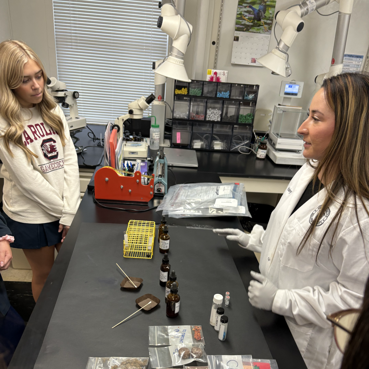 Gracie Shultzman observes as a forensics biologist tests drugs.