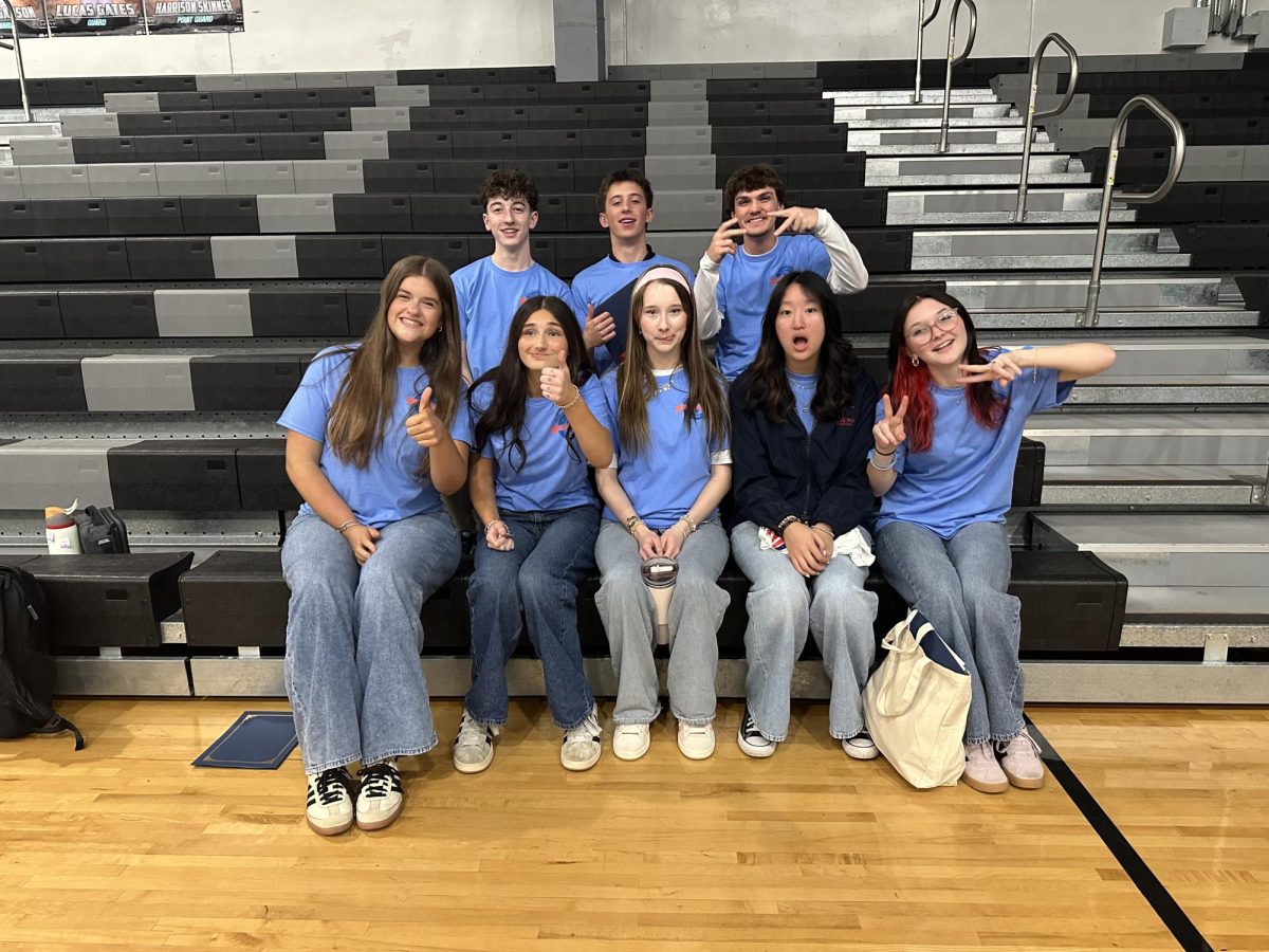 Members; Logan Greene, Chase McDaniel, Wells Palmer, Ella Michalopoulos, Ella Gallagher, Alivia Church, Bella Stone, and Kylee Jansen being silly while taking a group photo. 