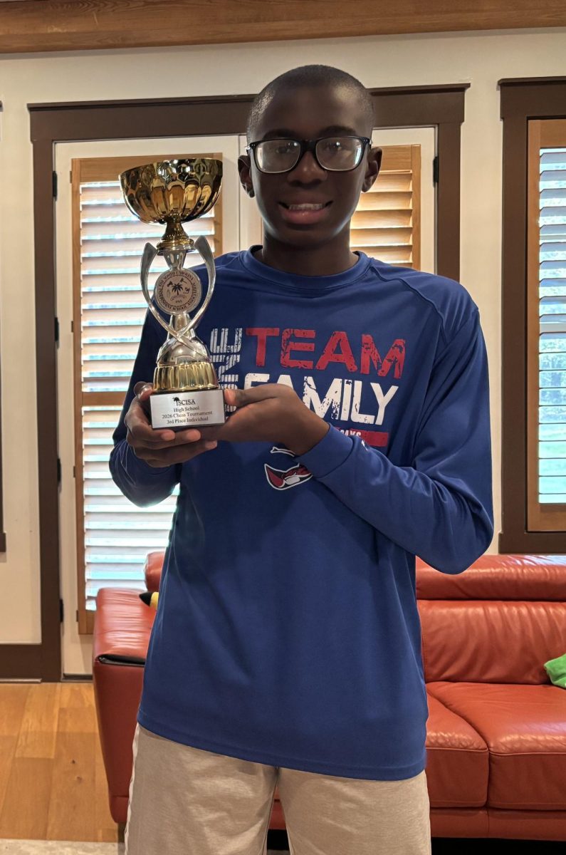 Ladi proudly holds his third place trophy.